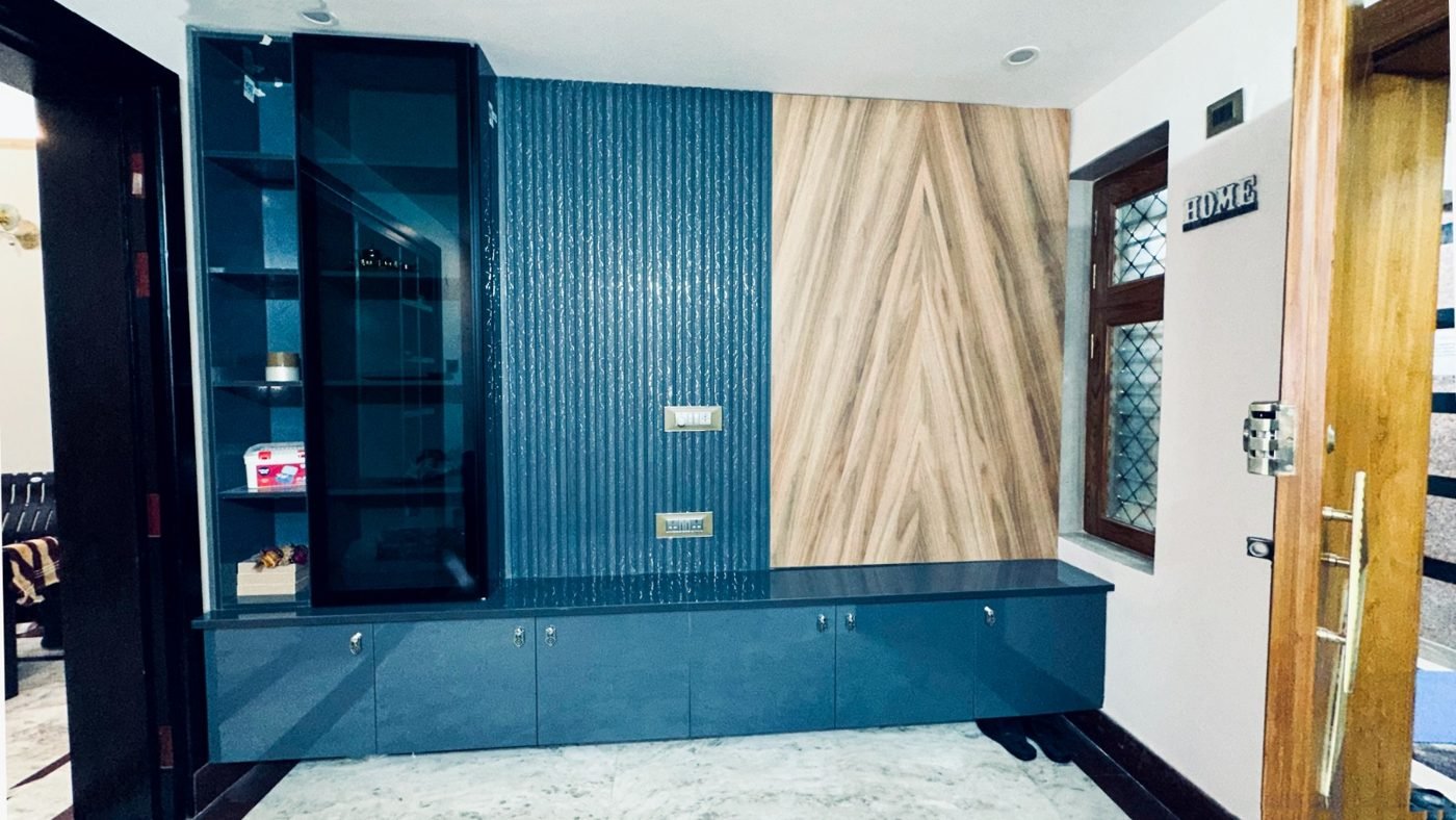 Completed blue gloss TV unit with chevron wood panel