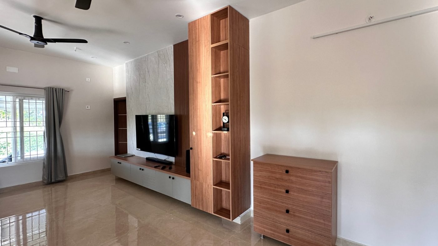 Completed walnut TV unit with tall open shelving